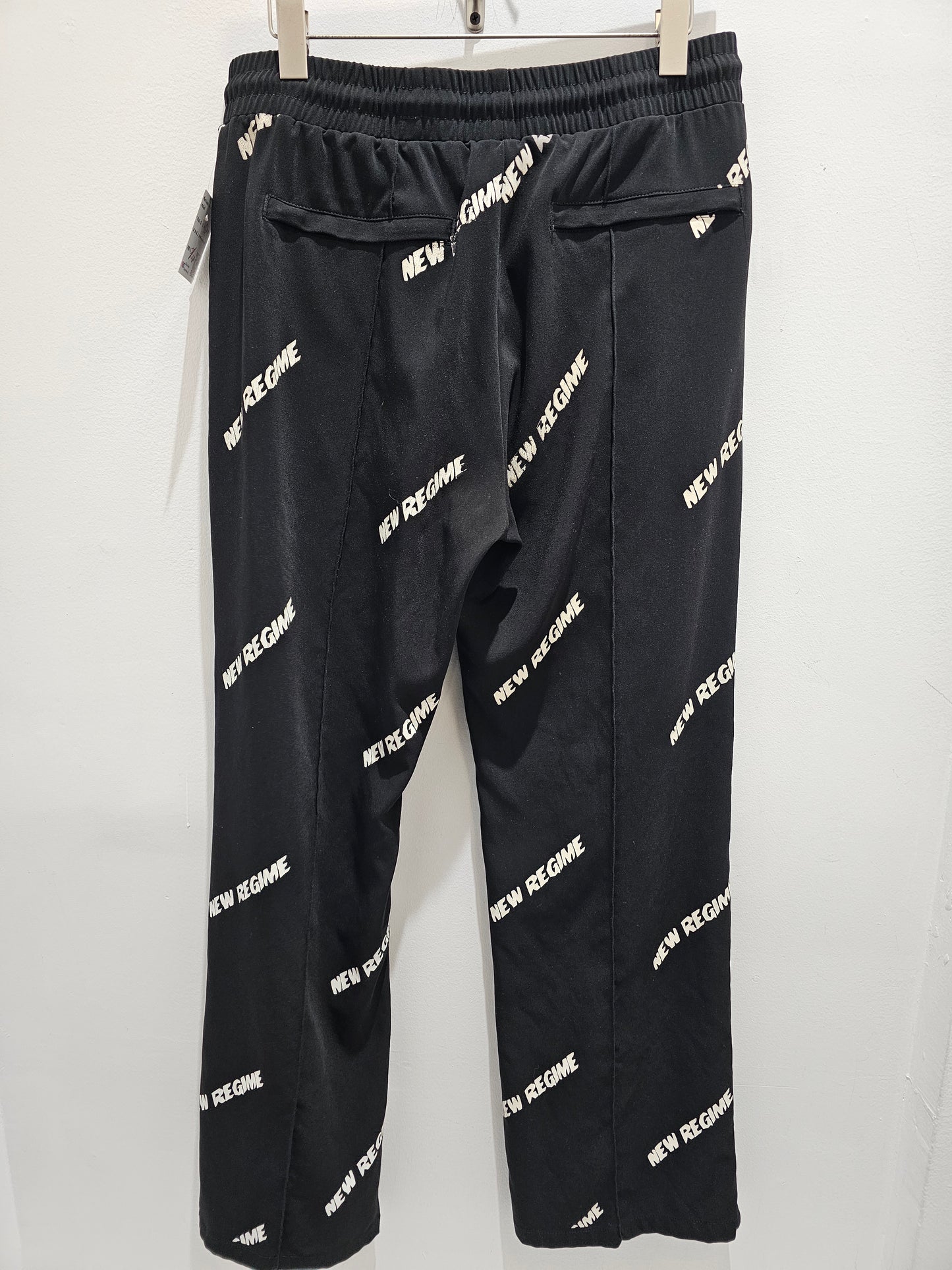 New regime all over print nylon black pants